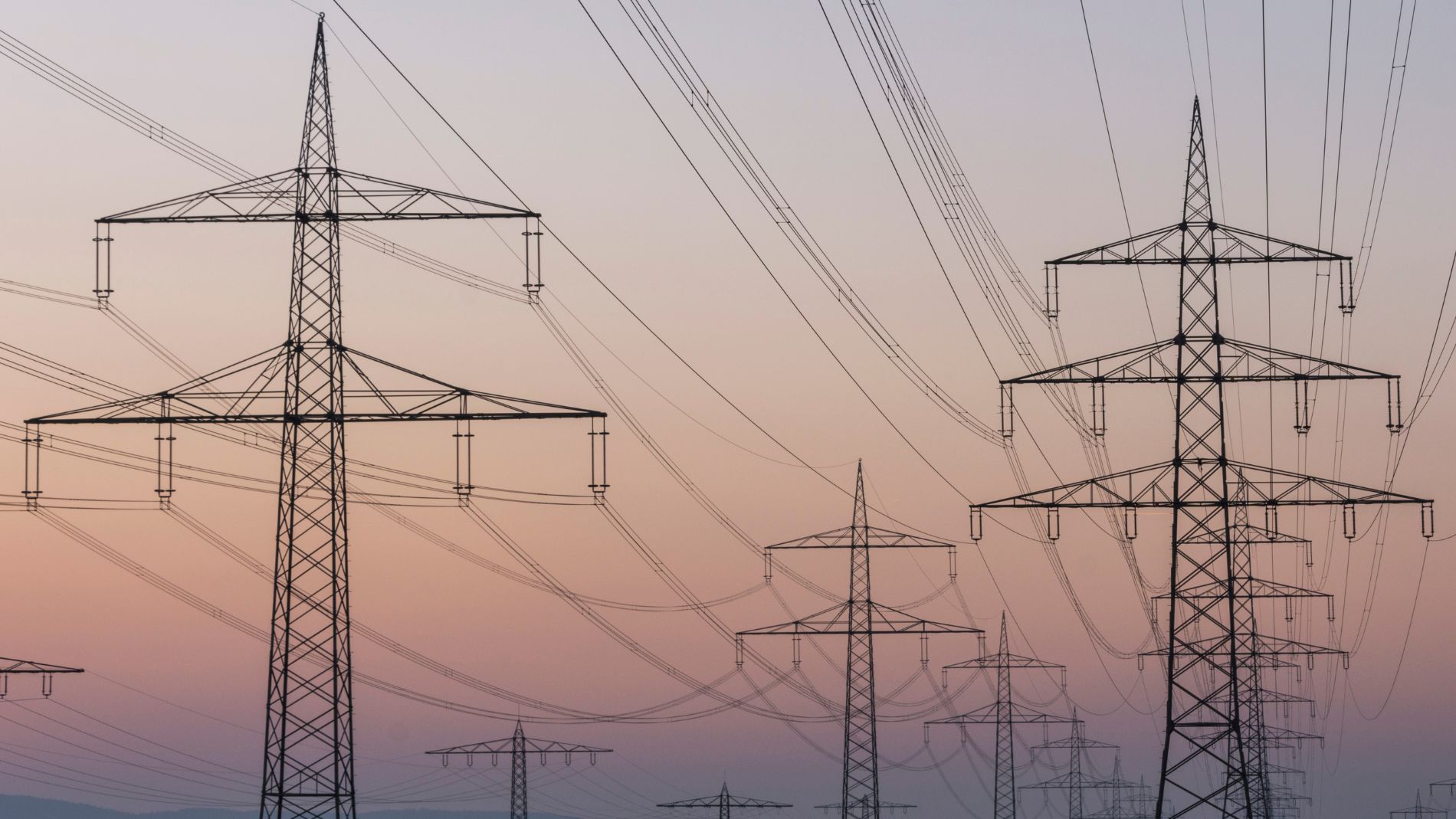 Several electricity pylons stand in a row