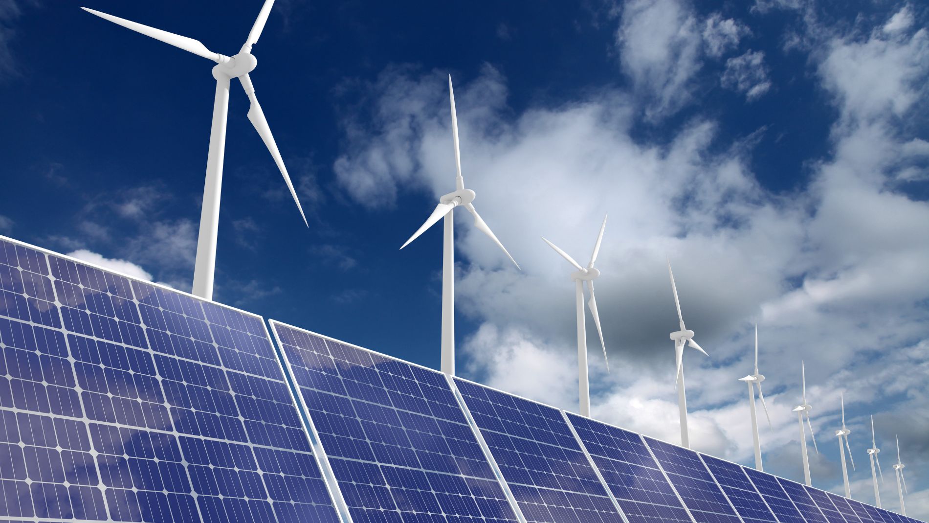 Combination of solar panels and wind turbines under a blue sky