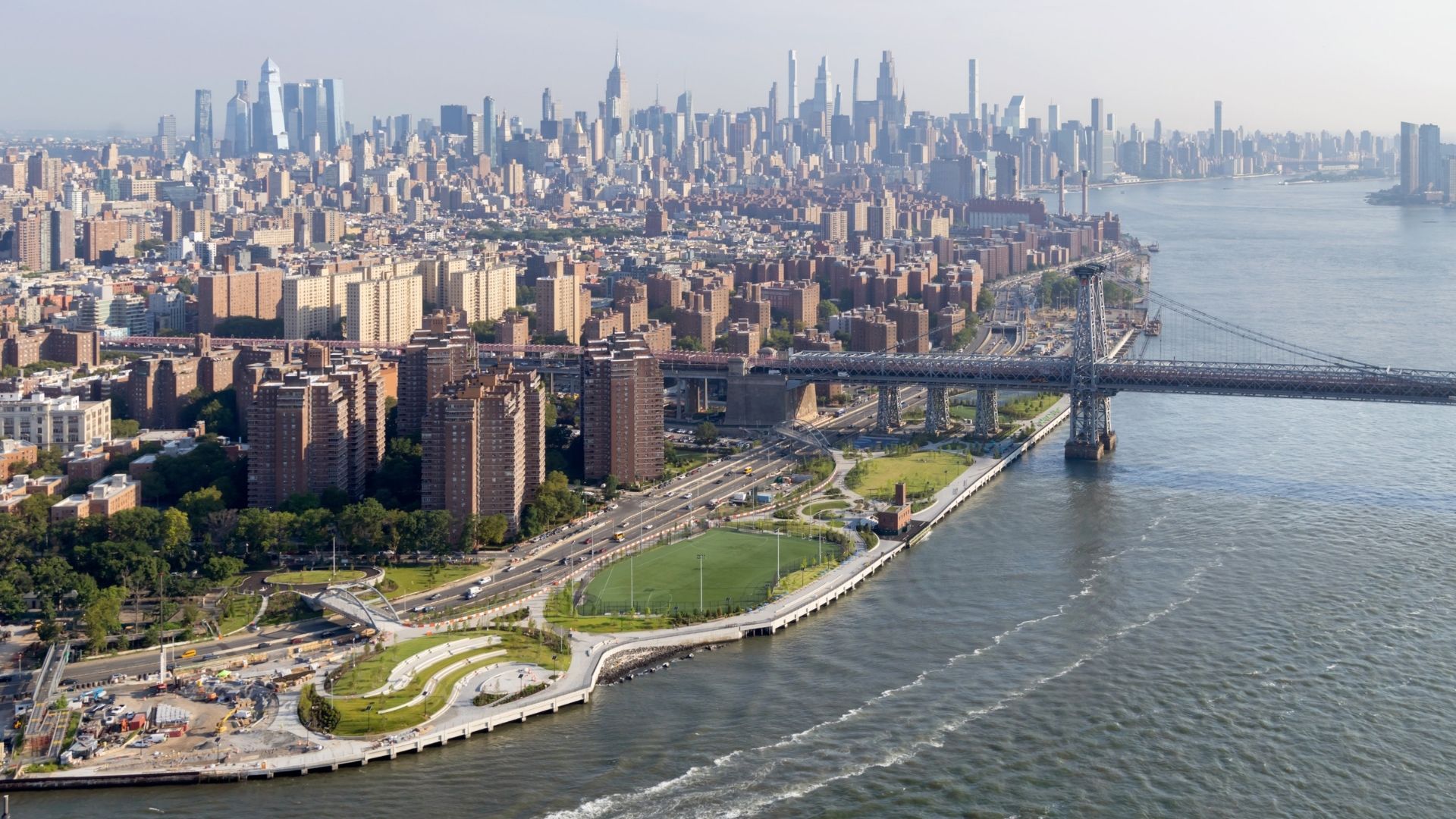 Aerial view of the New York skyline with a river bridge