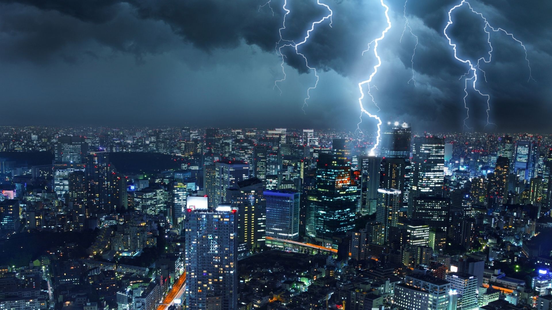 Thunderstorm over modern city skyline with lightning at night