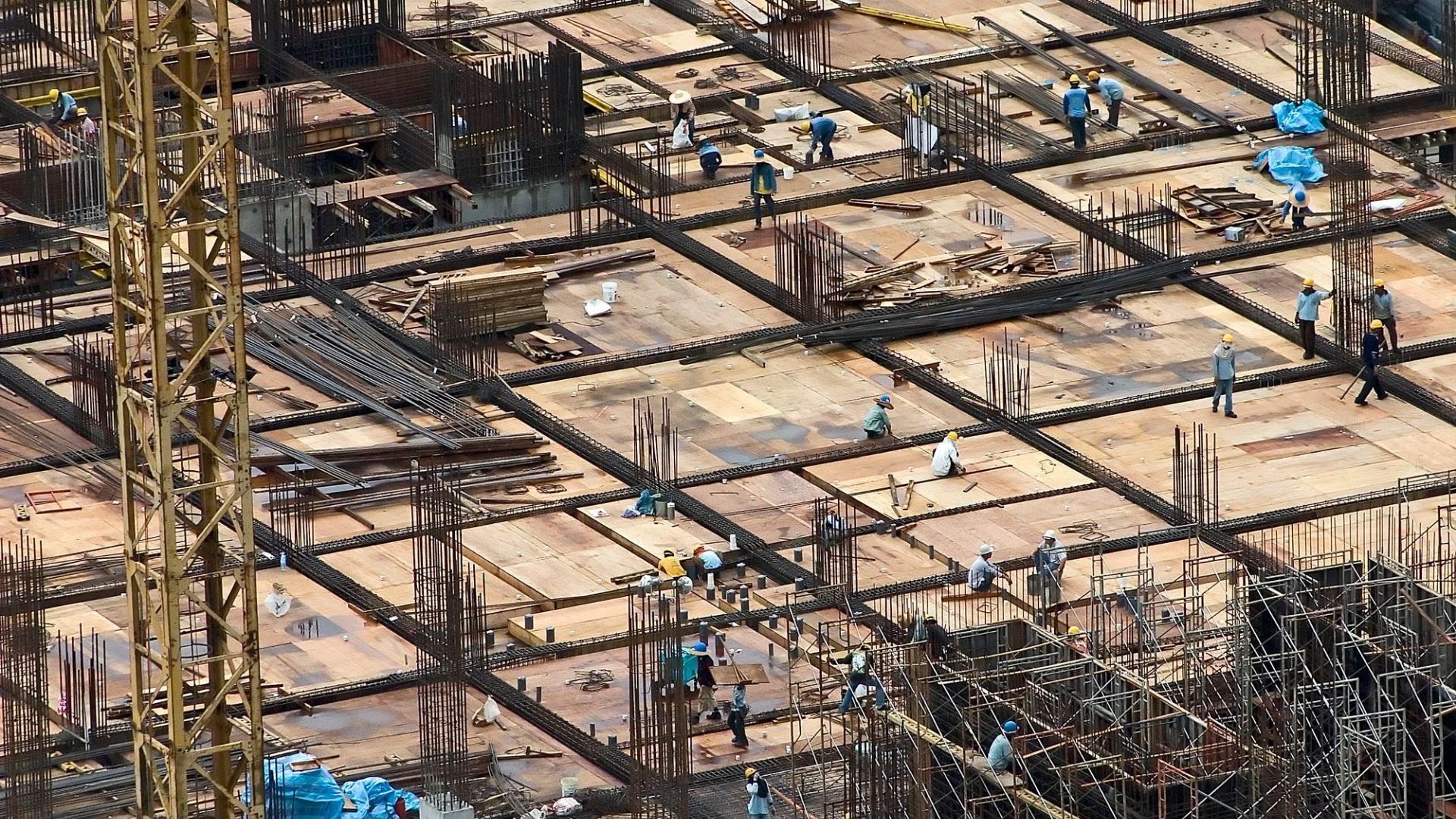 Large construction site with workers and steel framework