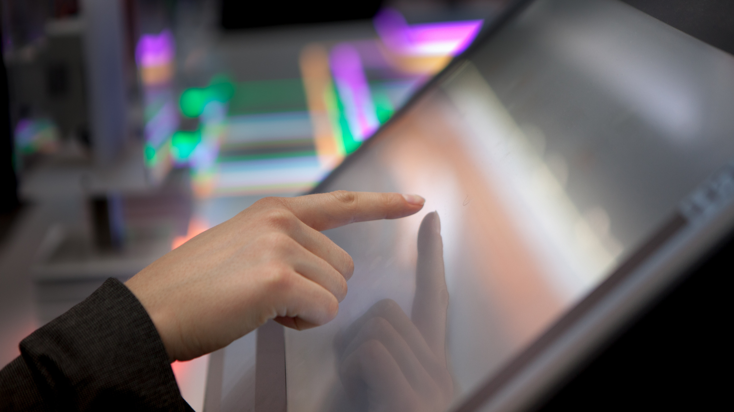 A woman taps on a display